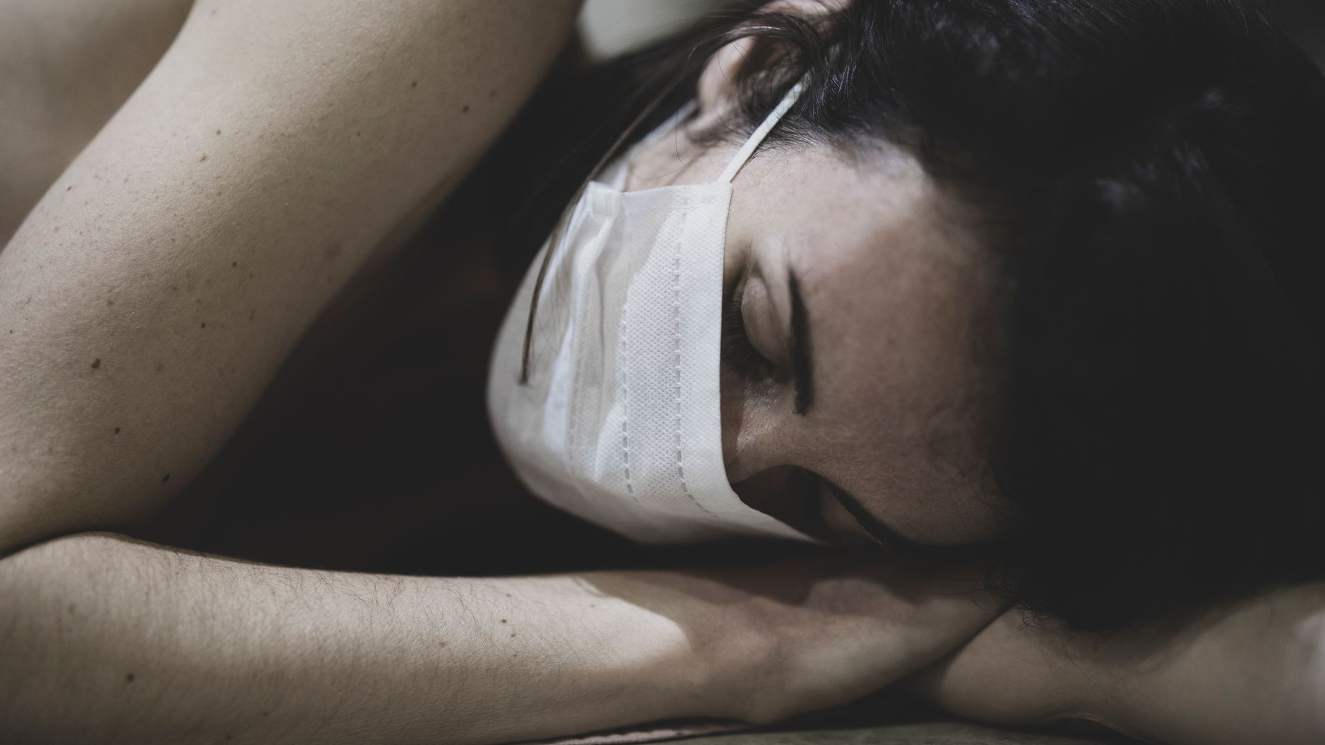 Modafinil for Long COVID Fatigue: Unlocking Energy Freckled woman with mask sleeping indoors, representing fatigue and recovery — modafinil for long covid fatigue