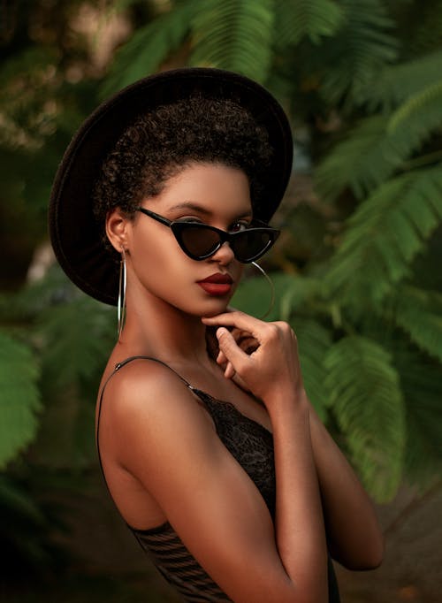 Woman in Black Tank Top Wearing Black Sunglasses