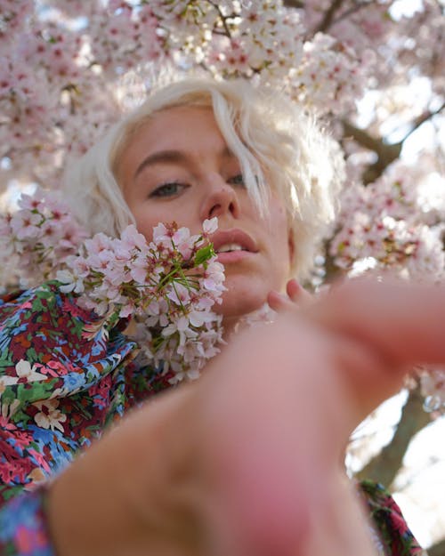Free Woman With Blond Hair Near Clusters of White Flowers Stock Photo