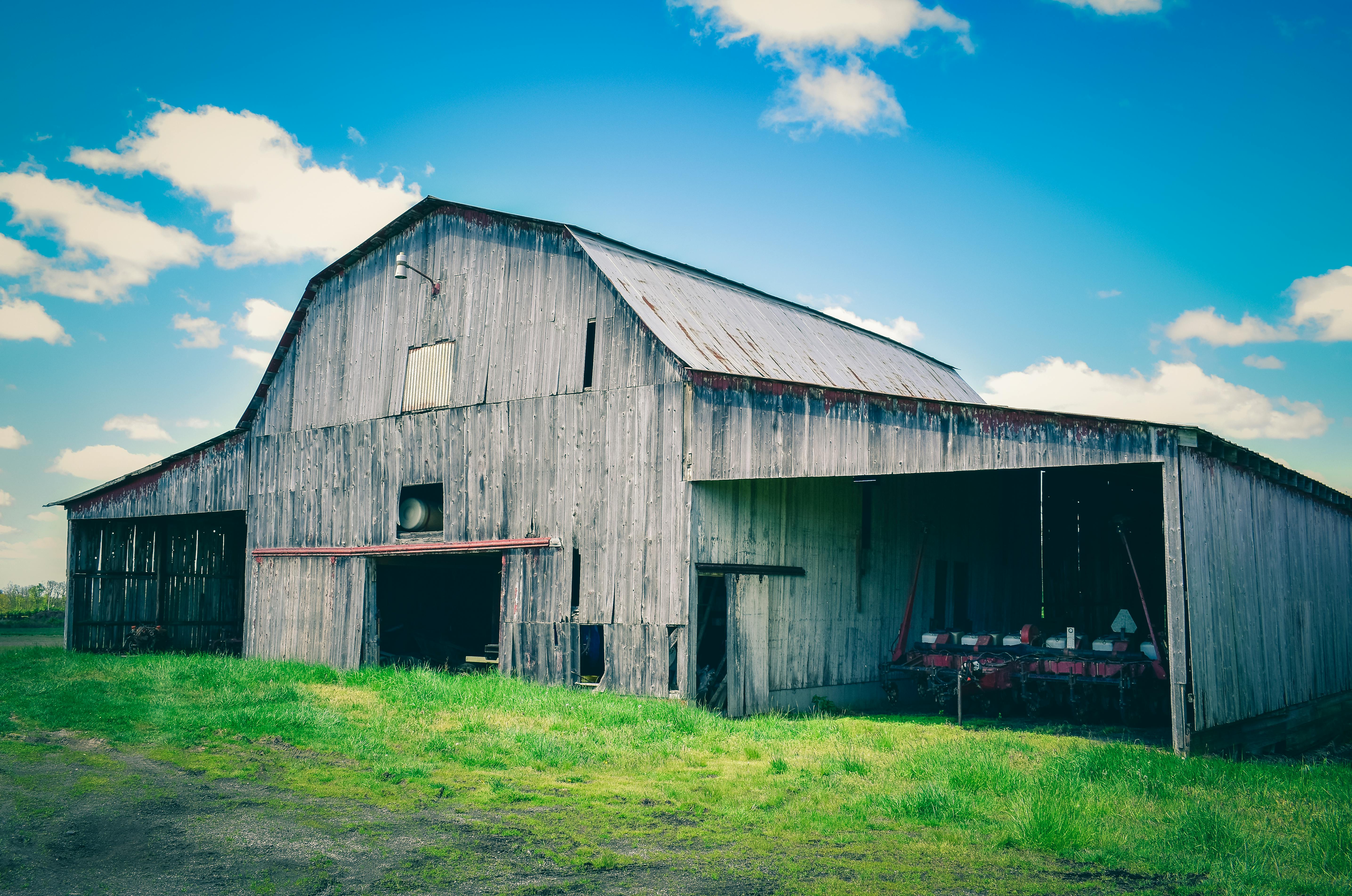 Old wooden barn near bright grass on farm · Free Stock Photo