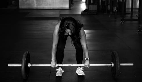 Free Woman Lifting a Barbell  Stock Photo