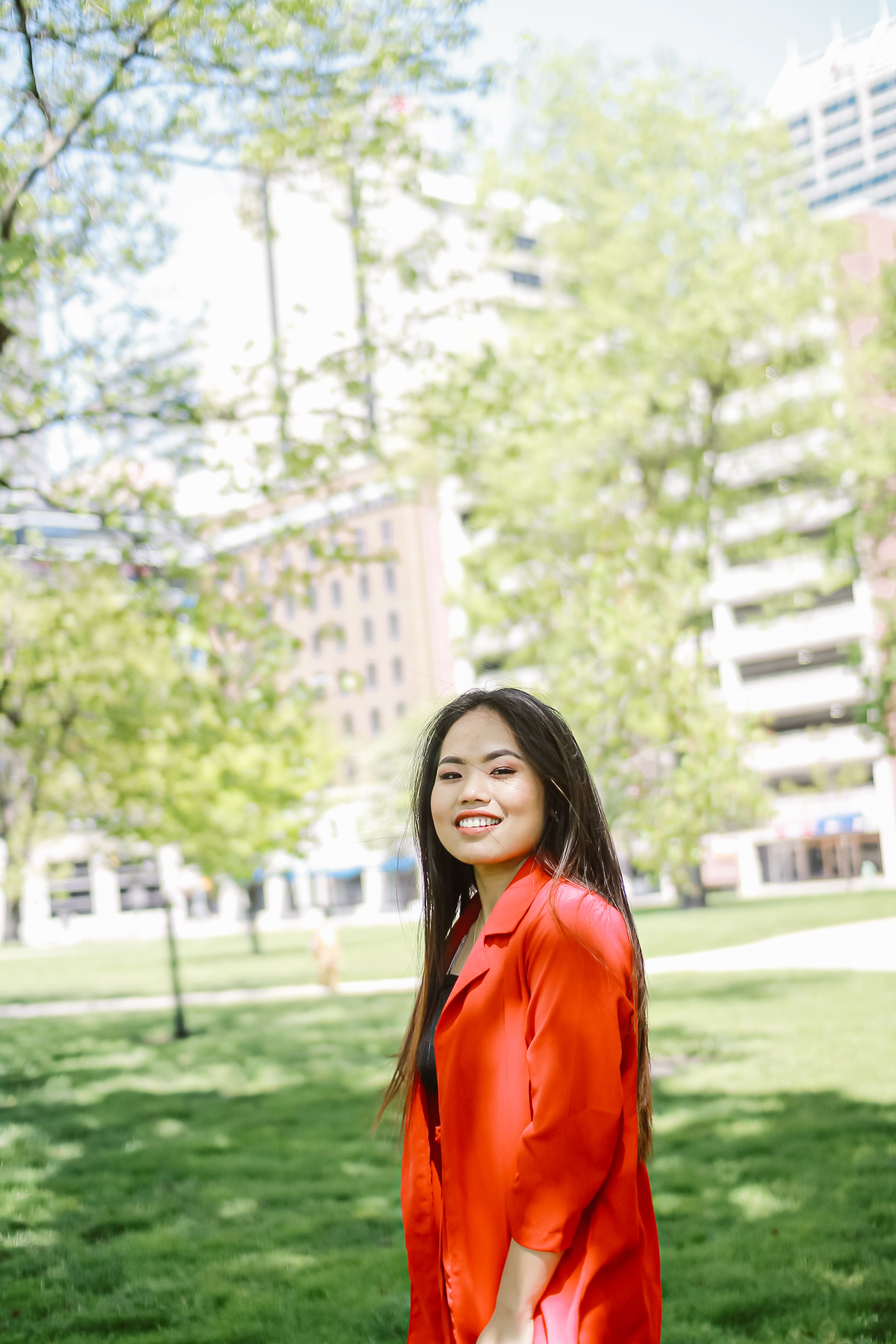 Photo of Woman in Red Blazer Standing on Grass Field · Free Stock Photo