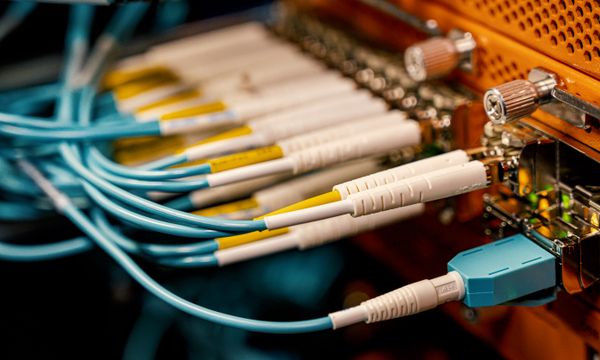 Fibre & ADSL Installation โ From above of optical switch equipment with many similar connectors with rubber cables and metal parts