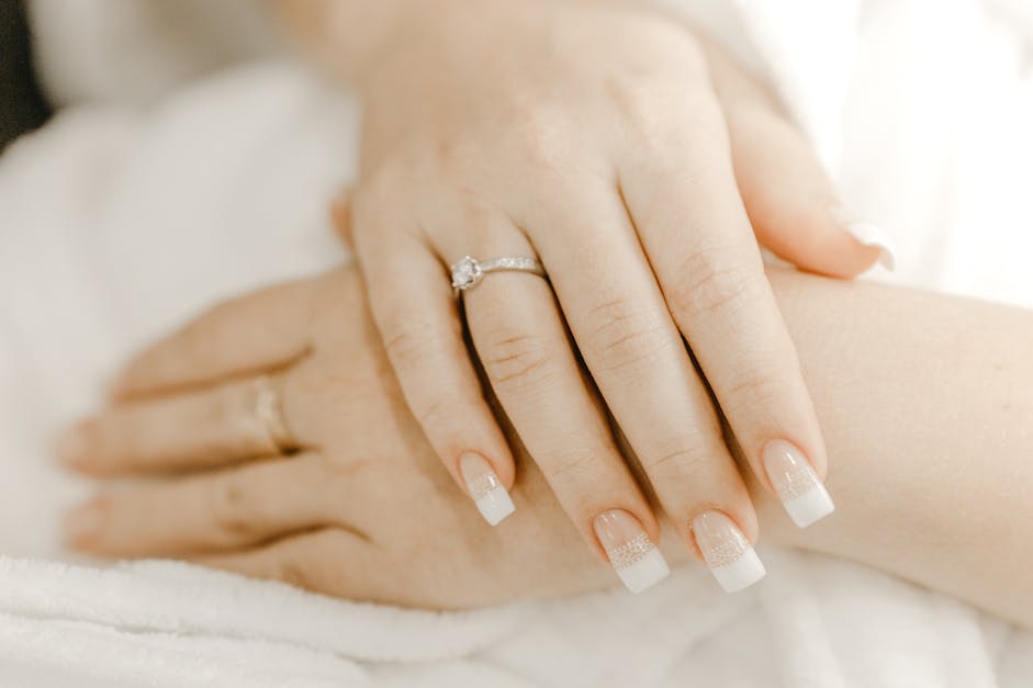 Hands of crop bride with manicure and ring · Free Stock Photo