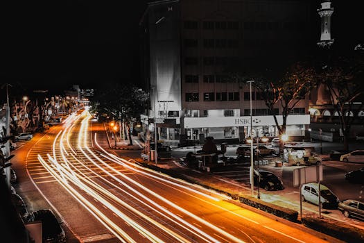 Stunning long exposure of city night showing vibrant light trails and urban activity.