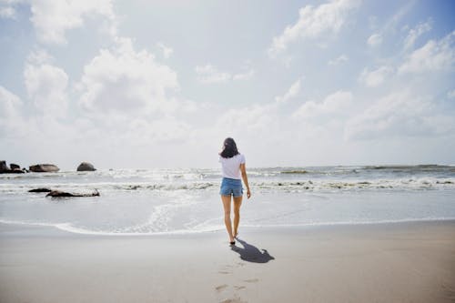 Woman Walking Towards the Sea