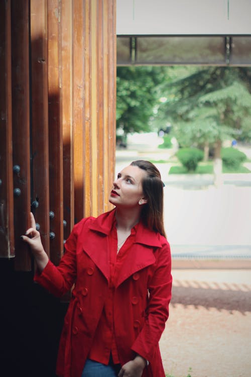 Woman in Red Coat Looking Up 