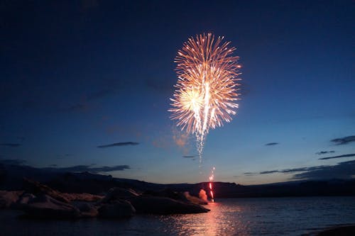 Free Fireworks Display over the Sea during Night Time Stock Photo