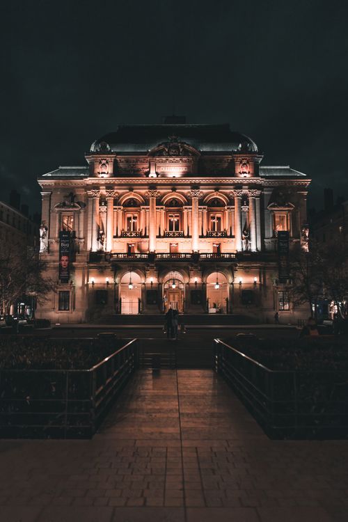 Free A grand historic building in Lyon, France, beautifully illuminated against the night sky. Stock Photo