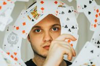 Playing Cards Around a Man's Face