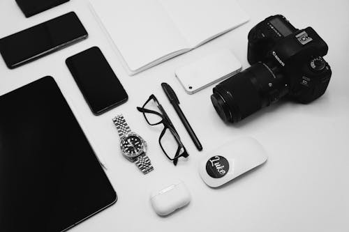 Free Black Camera and Wireless Gadgets on a Flat Surface Stock Photo
