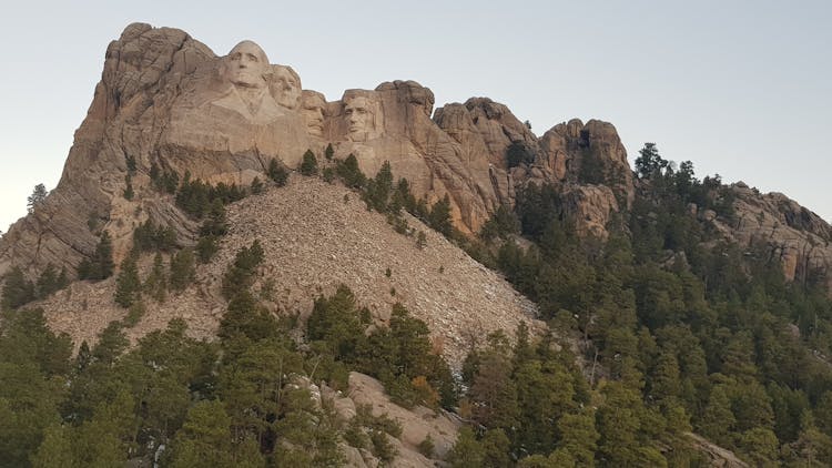 Gigantic Faces Carved On Rough Mountain Slope