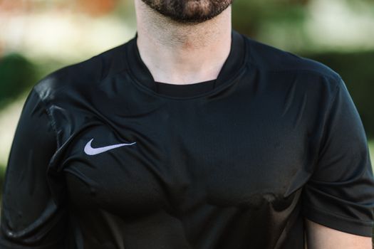 Man in a Wet Black Nike Crew Neck Shirt