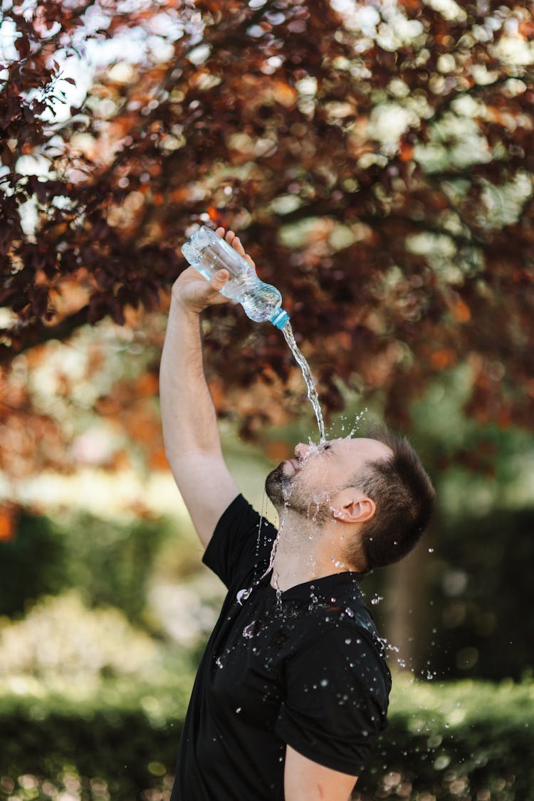 A Man Pouring Water On His Face 