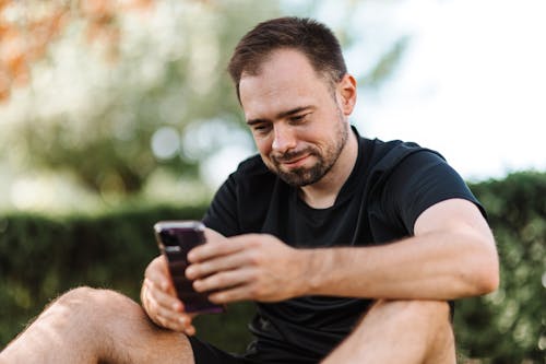 Free Man in Black Crew Neck T-shirt Using a Cellphone Stock Photo