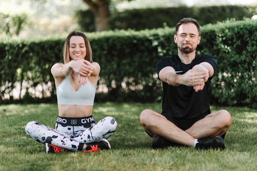 A couple enjoying a relaxing stretch outdoors, promoting fitness and wellness.