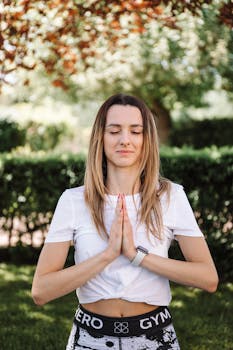 Relaxed woman practicing yoga in a sunny outdoor setting for wellness.