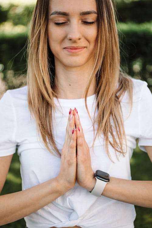 Close-Up Photo of Woman in White Shirt Doing Yoga