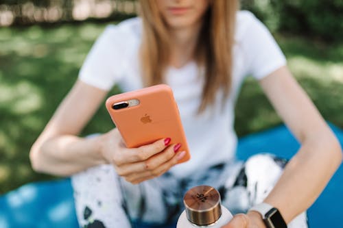 Free Close-Up Photo of a Woman Using Her Iphone Stock Photo