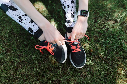 A Person Tying Her Sport Shoes