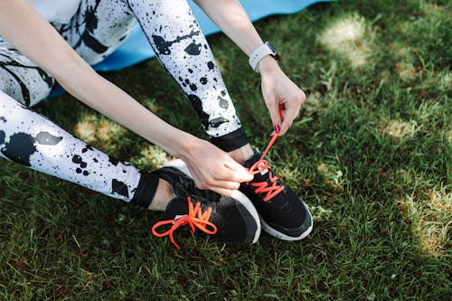 A Person Tying Her Sport Shoes
