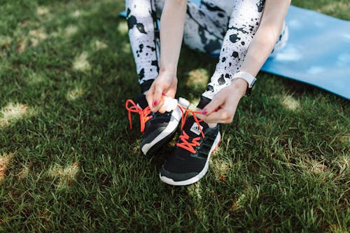 A Person Tying Her Sport Shoes