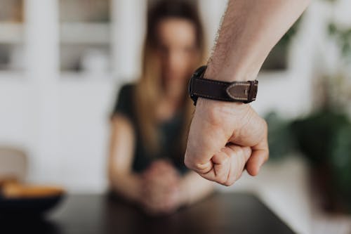 Free Hand Fist of a Person Wearing Leather Wristwatch Stock Photo
