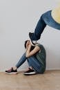 Woman in Blue Denim Jeans and Black and White Nike Sneakers