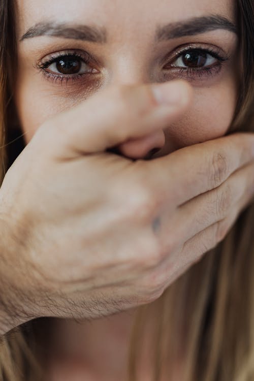 Woman Covering Her Face With Her Hand
