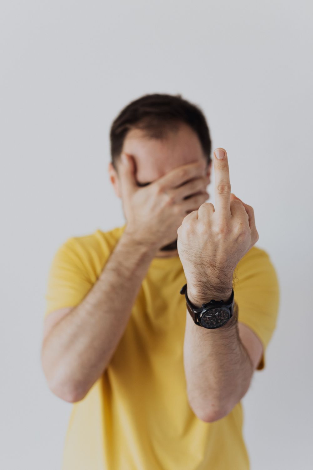 Man in Yellow Shirt Covering His Face · Free Stock Photo