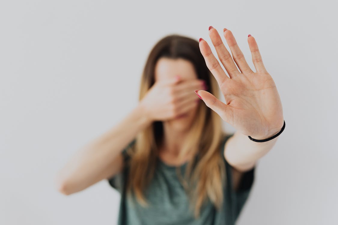 Free Woman Covering Her Face With Her Hands Stock Photo