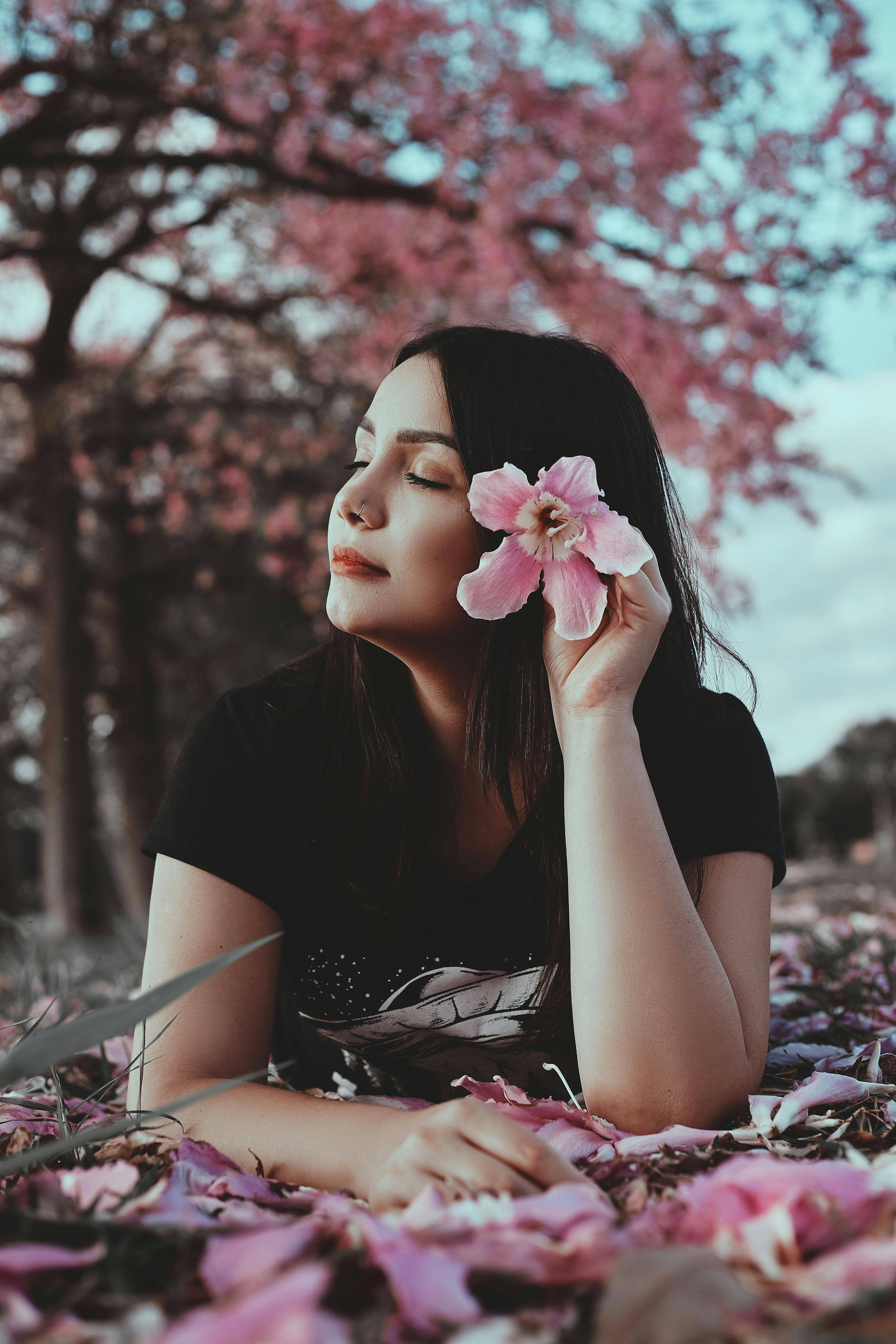 Woman Putting Pink Flower in Her Hair · Free Stock Photo