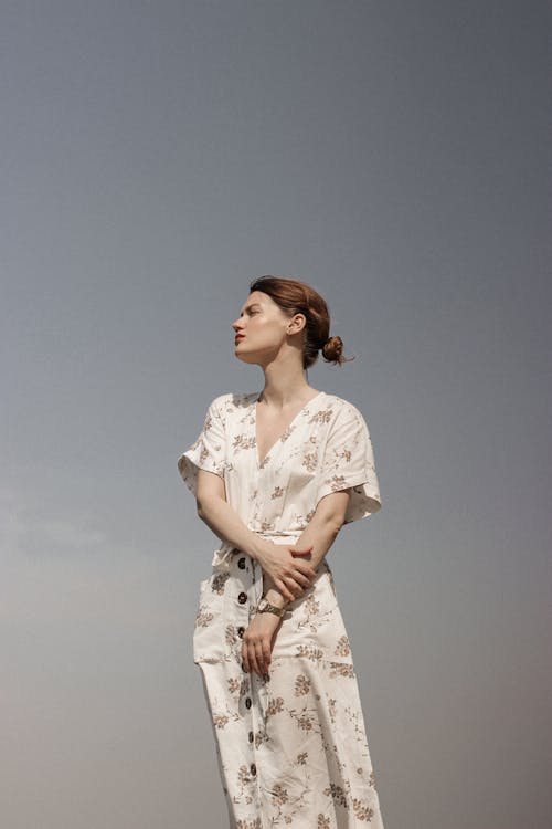 Woman in White and Brown Floral Dress