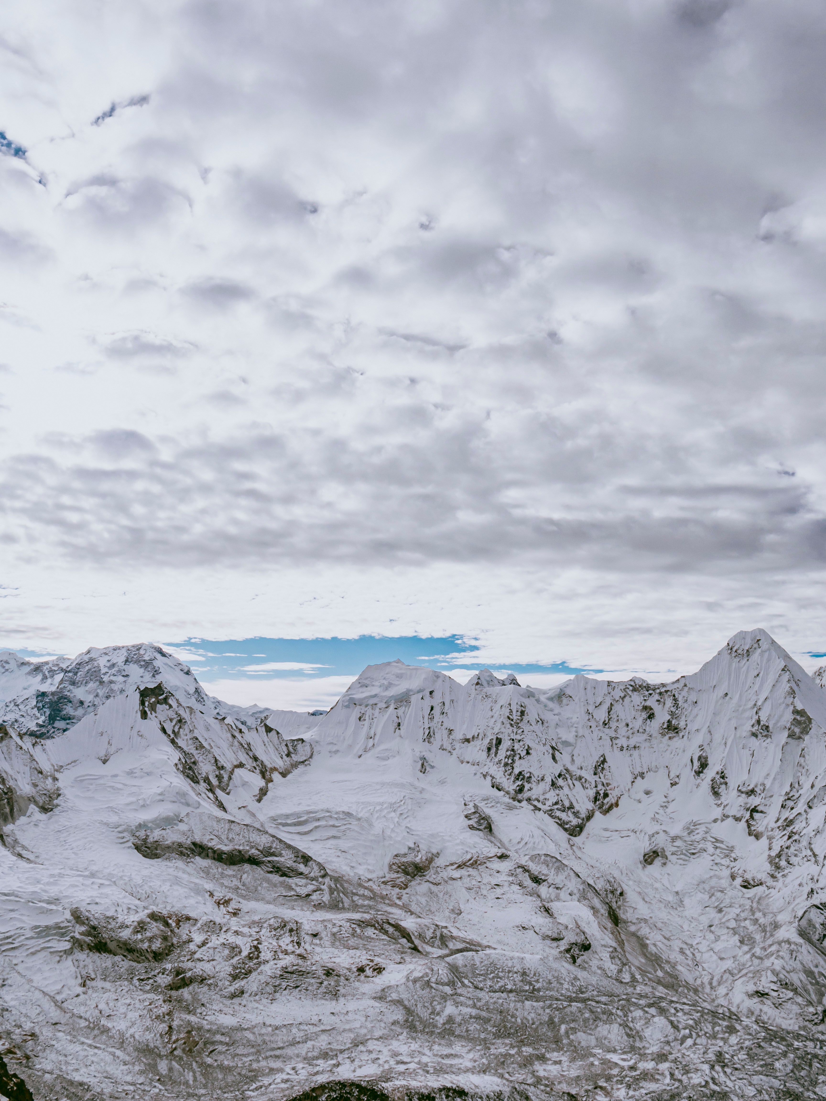Snow Capped Mountains Under the Cloudy Sky · Free Stock Photo