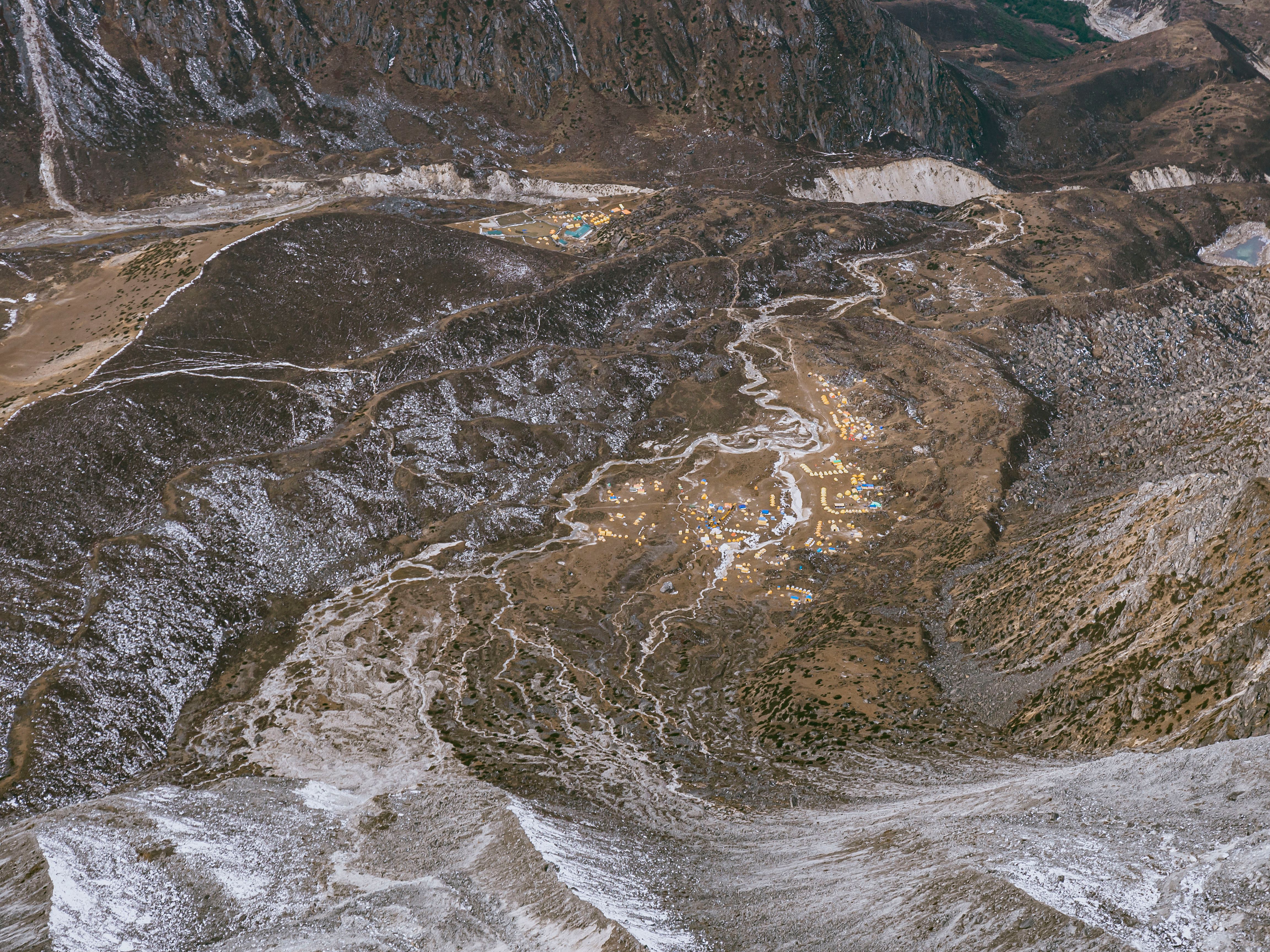 Unbeatable Everest Helicopter Tour- Kalapatthar Landing Guaranty Option Review 2026 - A breathtaking aerial view of Khumjung village nestled in the Nepalese mountains with snowy peaks.