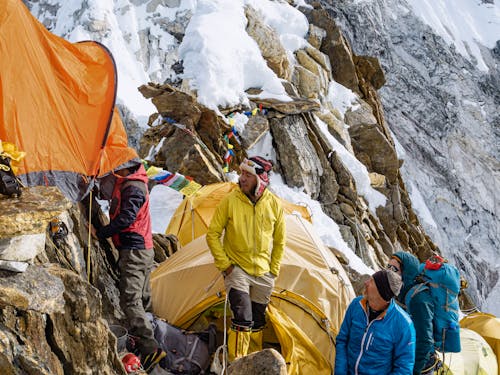 Free Mountain Climbers Establishing Camp Stock Photo