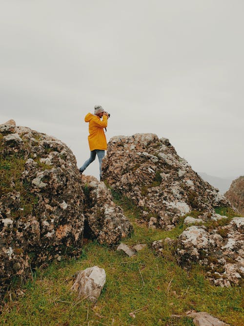 Anonymous female photographer shooting nature during hiking trip