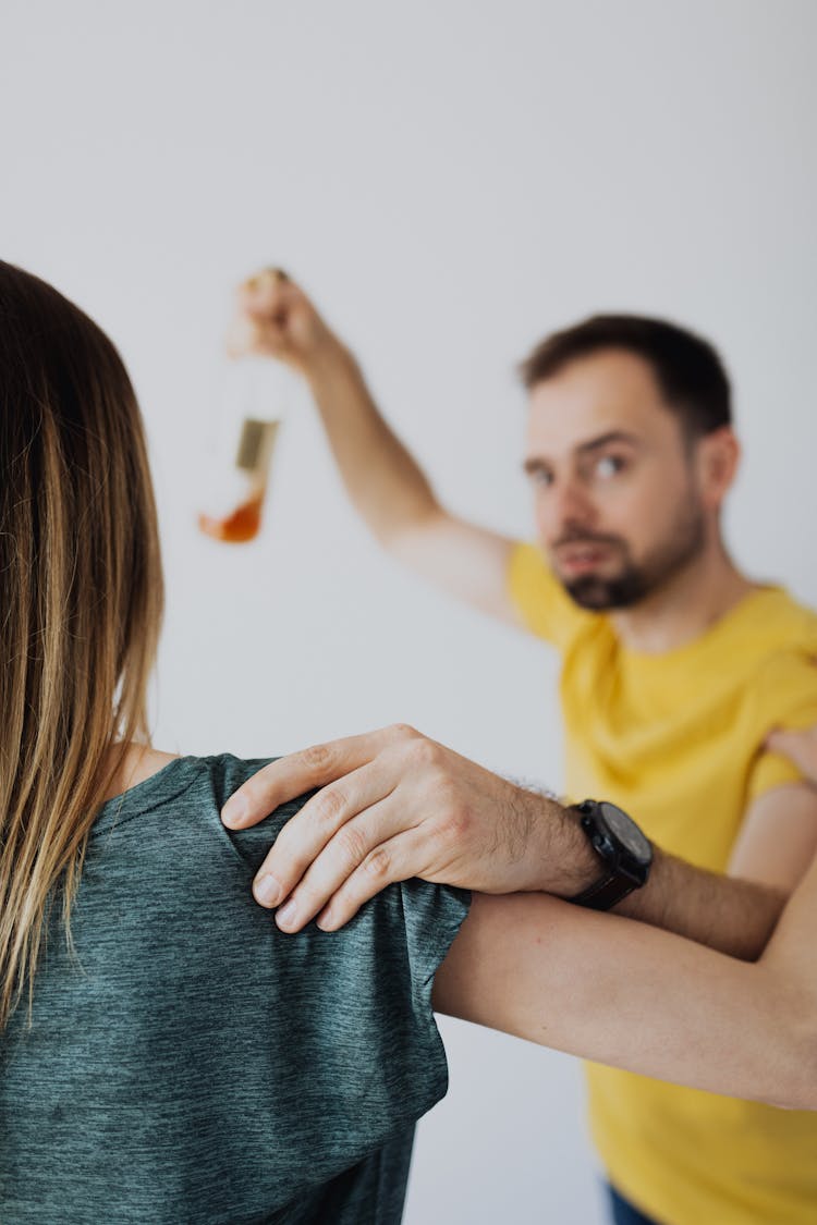 Abusive Man Holding A Bottle Trying To Hurt The Woman