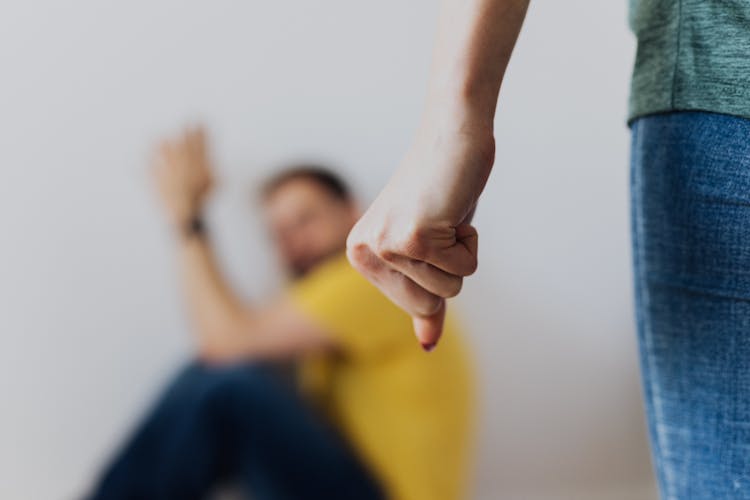 A Person Forming A Fist With Threat