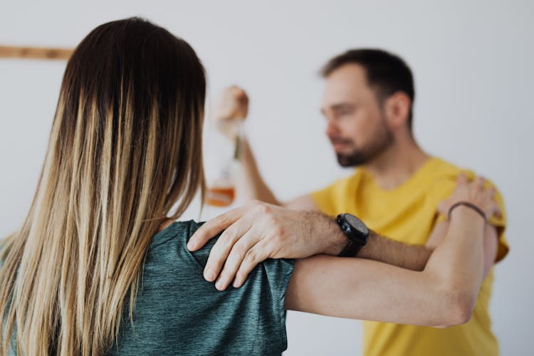 A Couple Grabbing Each Other On The Arm