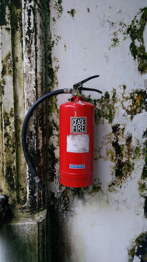 Red Fire Extinguisher Mounted on a Wall