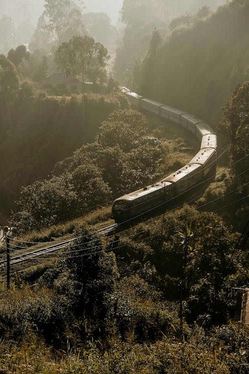 Free A Locomotive Train Traveling a Mountain Railroad Stock Photo