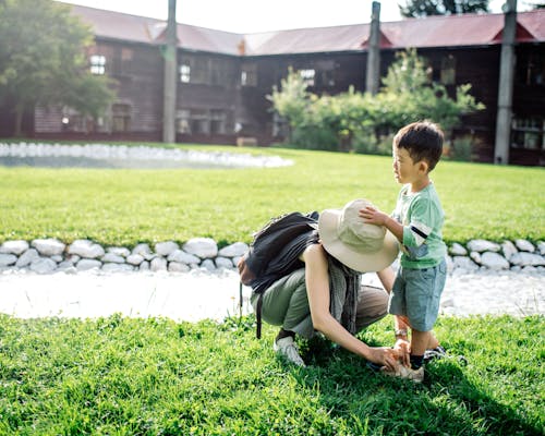 Mother Helping Her Son Put on Shoes