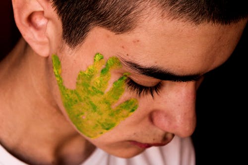 Green Hand Paint on the Person's Face 