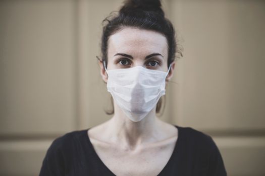 Woman in Black Shirt With White Face Mask Looking at Camera