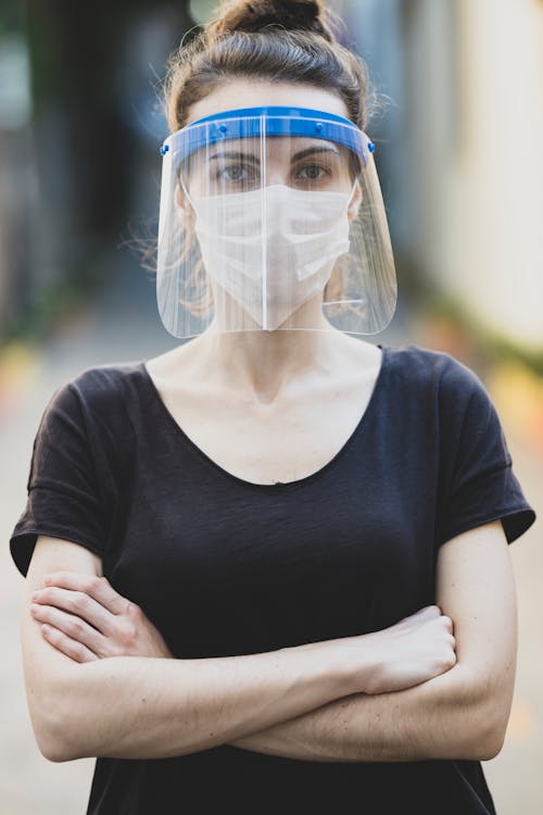 Free A Woman Wearing Face Shield and a Face Mask Stock Photo