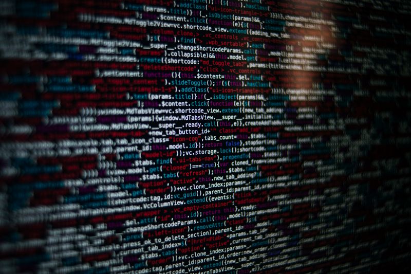 Close-up of colorful source code displayed on a computer monitor