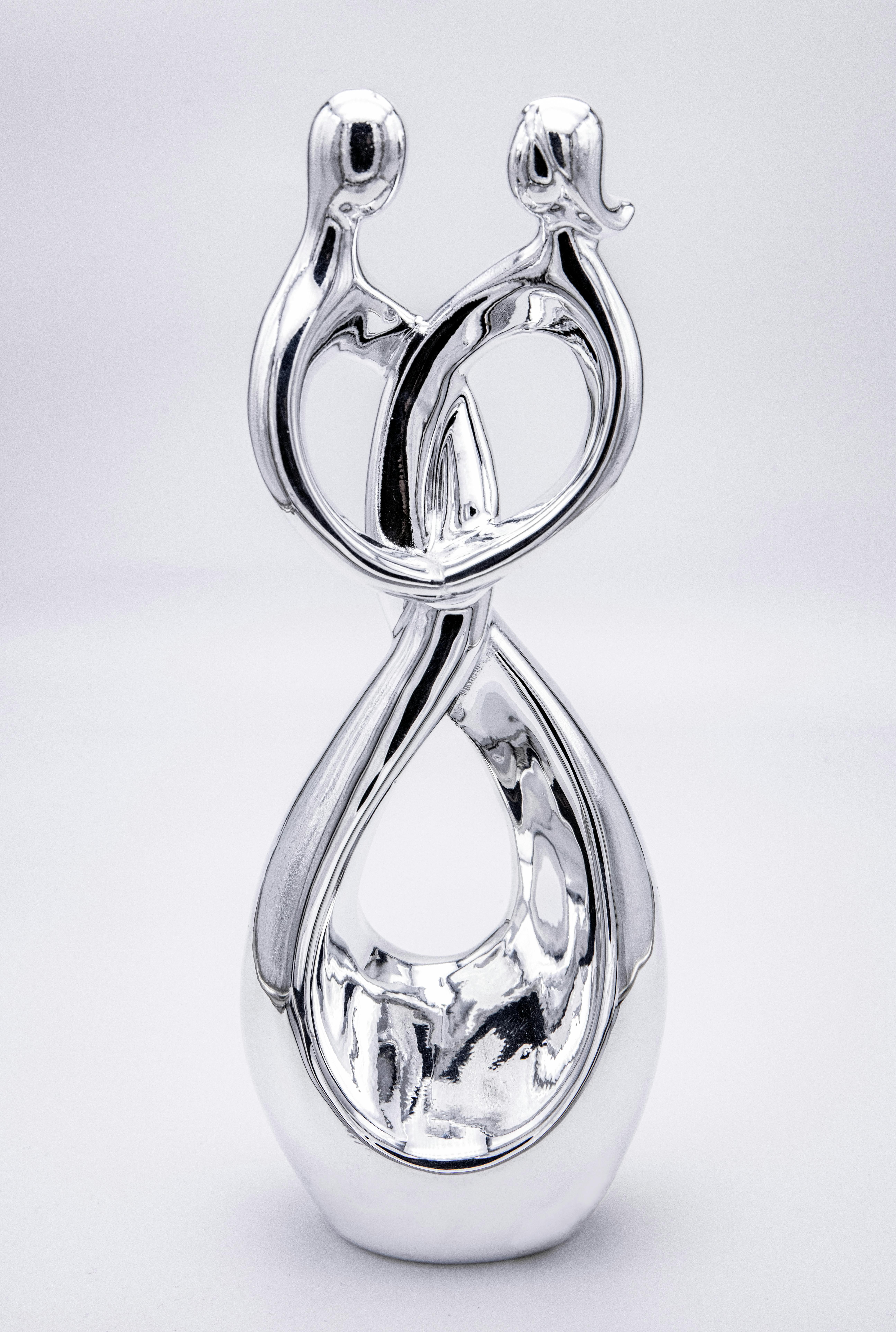 silver sculpture of lovers