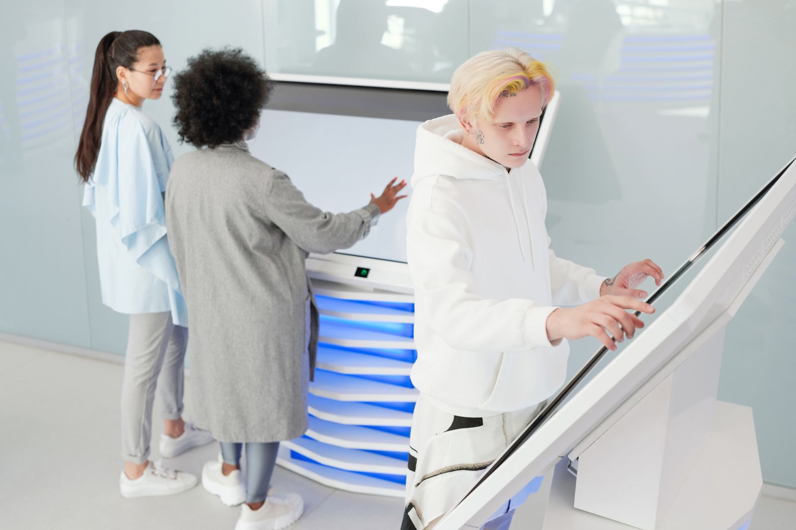 Team using large futuristic touchscreens to model and analyze systems