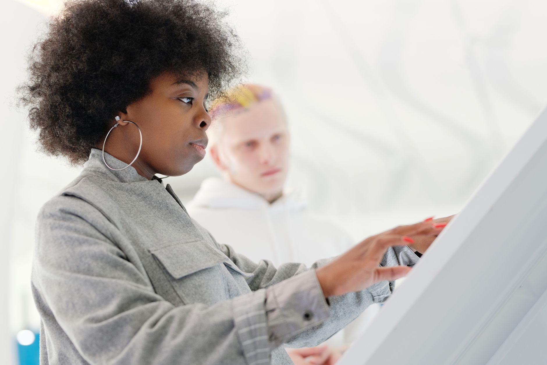 Diverse group of people interacting with AI interfaces, some looking thoughtful or concerned